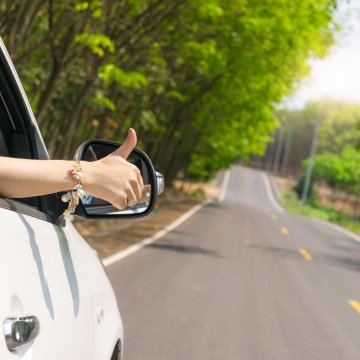 top 10 extended car warranty providers car on the road sunny background hand giving okay sign on the car window